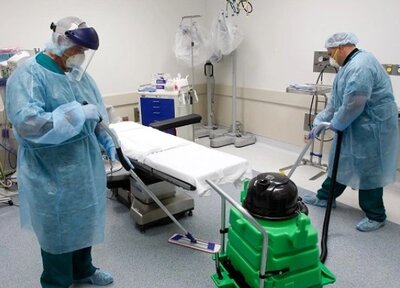 Janitorial staff cleaning a surgery center to maintain a sterile medical environment.